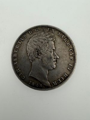 a silver coin with a man ' s face on it