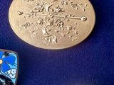 three different types of brooches are displayed on a blue surface