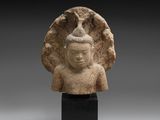 a stone head of a person with a bird on its head