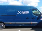 a blue van that is parked in a parking lot