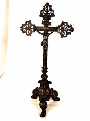 a cross that is on a stand with a white background