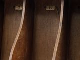 a wooden shelf that has a bunch of books on it