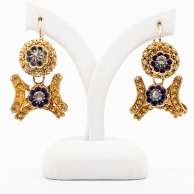 an image of a pair of earrings with blue and white stones