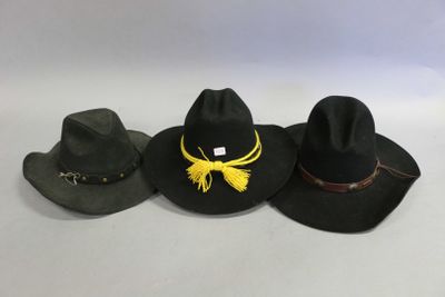 three hats are lined up in a row on a white surface