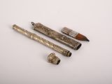 three different types of pens and a pipe on a white surface