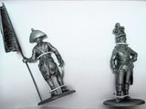 two figurines of a man and a woman holding flags