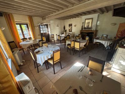 a room with a table, chairs, and a fireplace in it