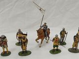 seven figurines of knights on horseback with flags and spears