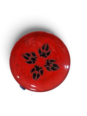 un frisbee rouge orné d'un motif noir
