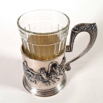 a silver cup with a handle and a handle on it