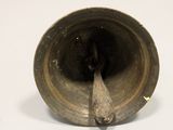 a small metal object sitting on a white surface