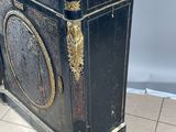 a black and gold cabinet with a marble top