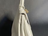 a white purse that is sitting on a table