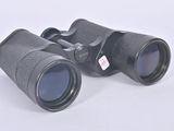 pair of binoculars on a white surface with a white background