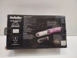 a box with a hair dryer and a comb in it