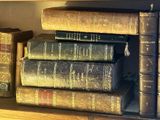 many old books sitting on a shelf in a library