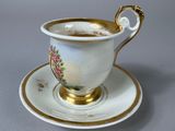 a cup and saucer on a saucer on a table