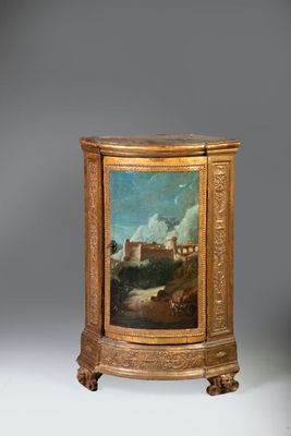 une image représentant un tableau posé sur un support en bois, avec, en arrière-plan, un tableau représentant un château