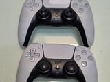 two video game controllers sitting next to each other on a table