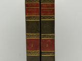 a pair of books sitting on top of each other on a table