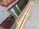 a television sitting on top of a pallet in a warehouse