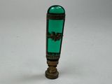 a green glass bottle with a gold decoration on it
