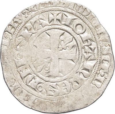 a close up of a coin with a cross on it