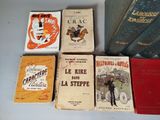 several books are lined up on a table with a white background