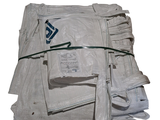 a stack of newspapers wrapped in plastic and tied to a string