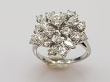 a close up of a diamond ring on a white surface