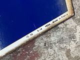 a picture of a blue sign on the ground