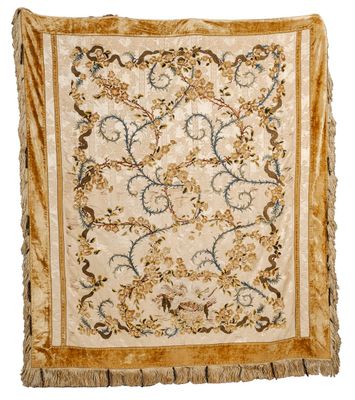 a beige and blue rug with a floral design on it