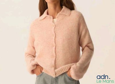 a picture of a woman wearing a pink sweater and jeans
