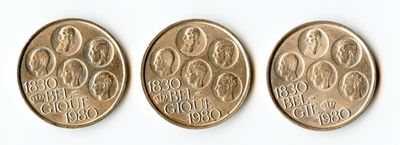 three coins are shown on a white surface, one has a woman and the other has a man