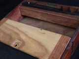 a wooden box that has a knife inside of it