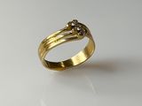 a gold ring with two diamonds on top of it