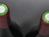 two bottles of wine sitting next to each other on a table