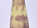a vase that has a picture of a boat in the water