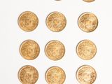 a lot of gold coins on a white surface