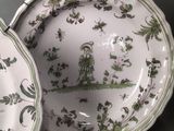 two plates that have green and white designs on them