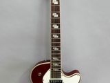 a red electric guitar hanging on a wall with a white background