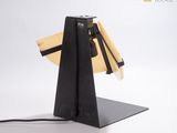 a black table lamp that has a surfboard on top of it