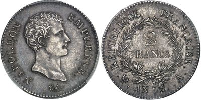 a silver coin with a bust of a man on it