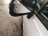 a side view mirror of a car that is parked in a garage