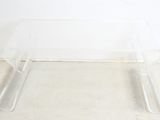 clear acrylic coffee table with two legs and a glass top