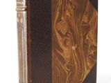an old book with a brown leather cover and a wooden cover