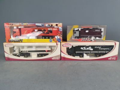 two boxed toy trains are sitting on a table next to each other
