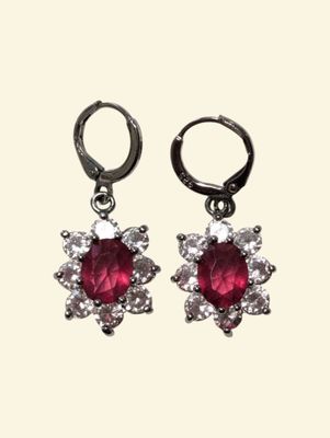 pair of ruby and diamond earrings on a white background