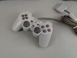 a video game controller sitting on a table next to a keyboard