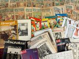 a pile of old books and magazines on the floor